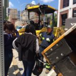 employee showing teens asphalt equipment