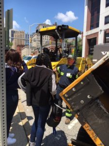 employee showing teens asphalt equipment