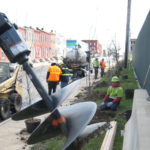 large auger digging holes for tree planting