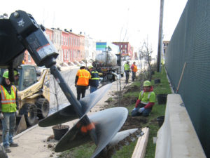 large auger digging holes for tree planting